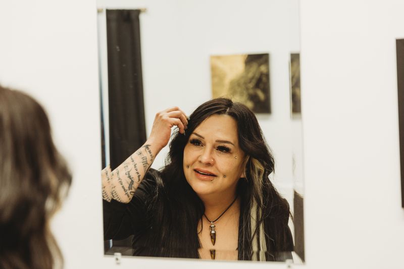 Client checking a new piercing in the mirror